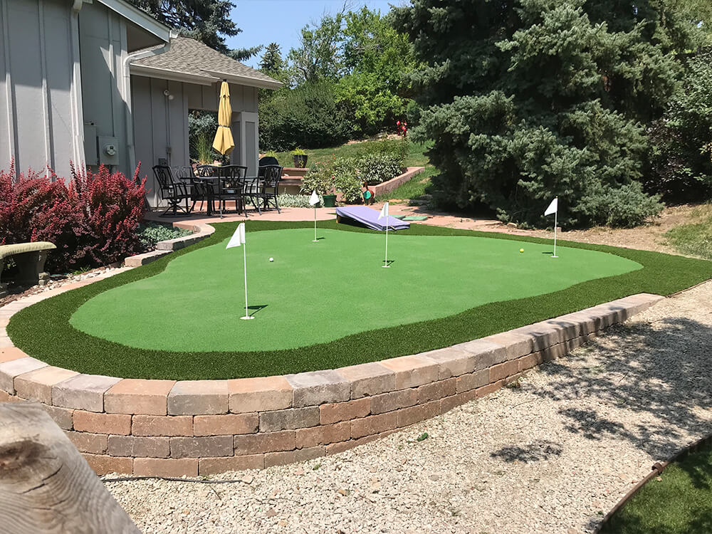 Denver putting green with paver stone wall 