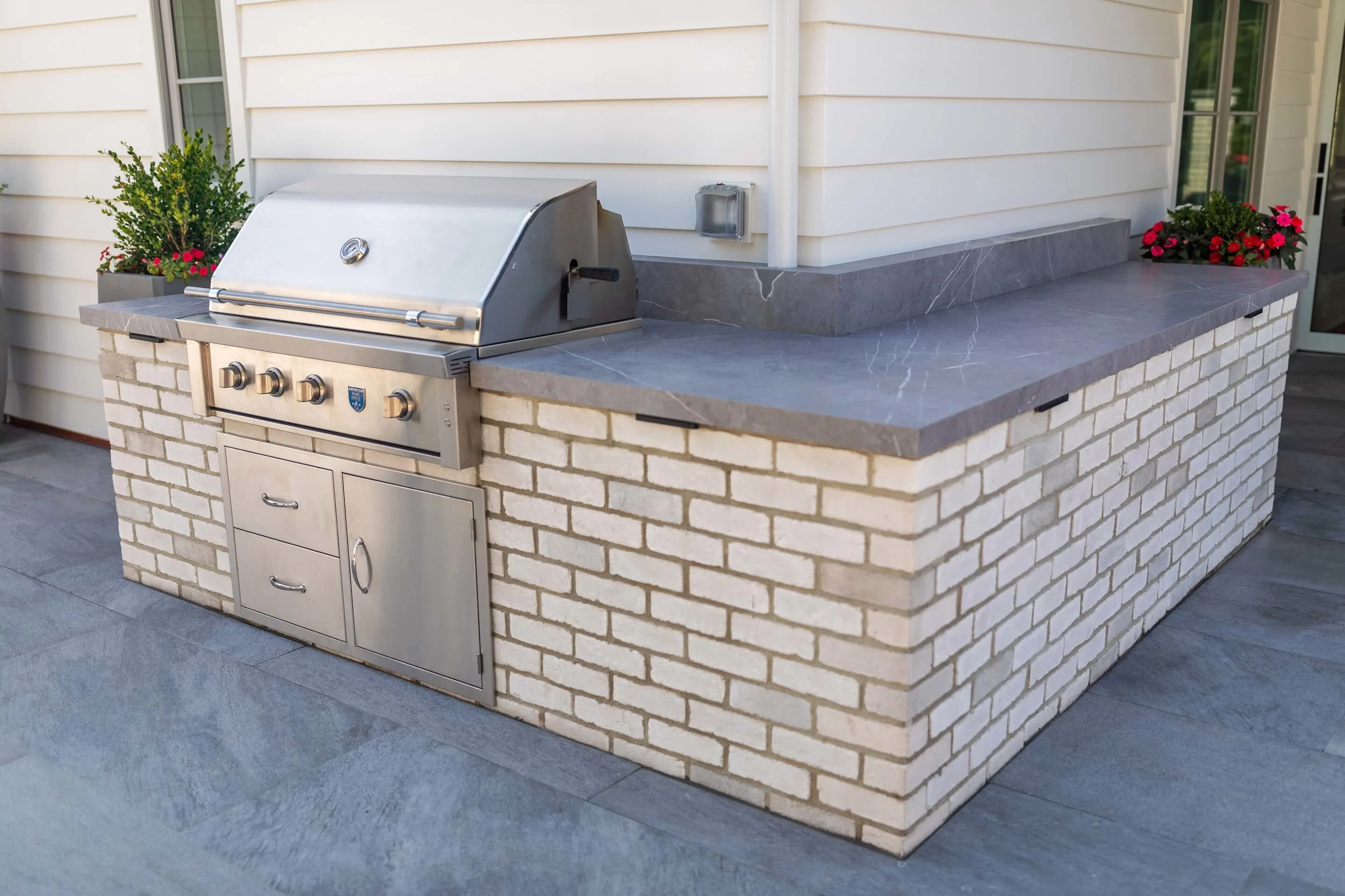 Outdoor grilling station with granite countertops for prep and dining