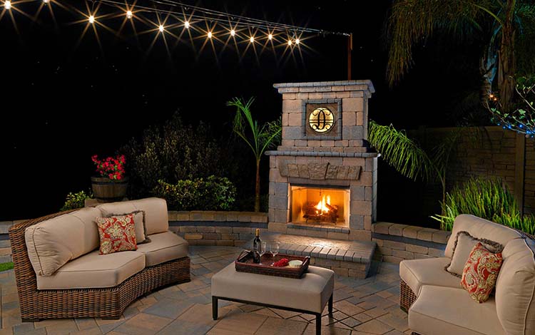 Outdoor fireplace, cozy, fire, lit, wine, paver patio, patio furniture, outdoor living, outdoor lighting, backyard, fire, paving stones, California, night
