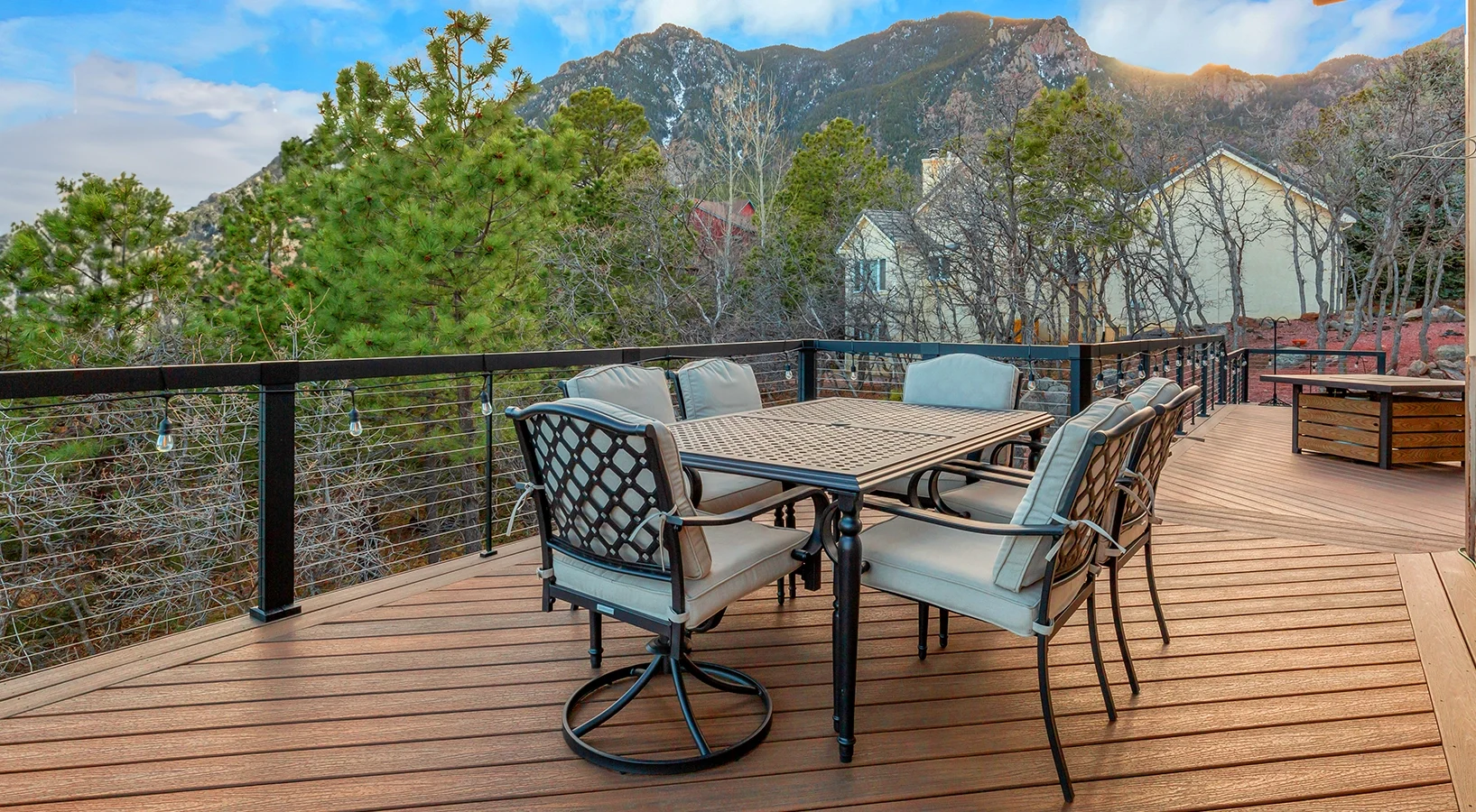 Lovely composite deck built by forest with fire pit and chairs