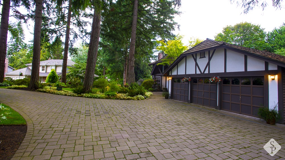 tudor home with paver driveway