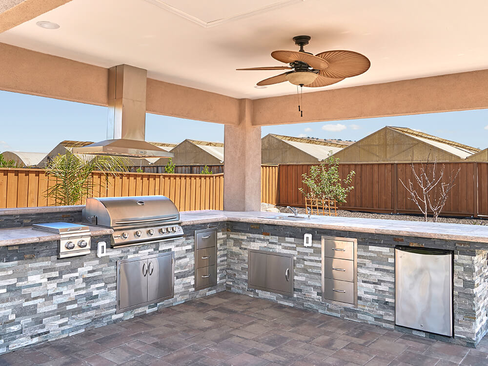 Outdoor kitchen made of stone with pergola