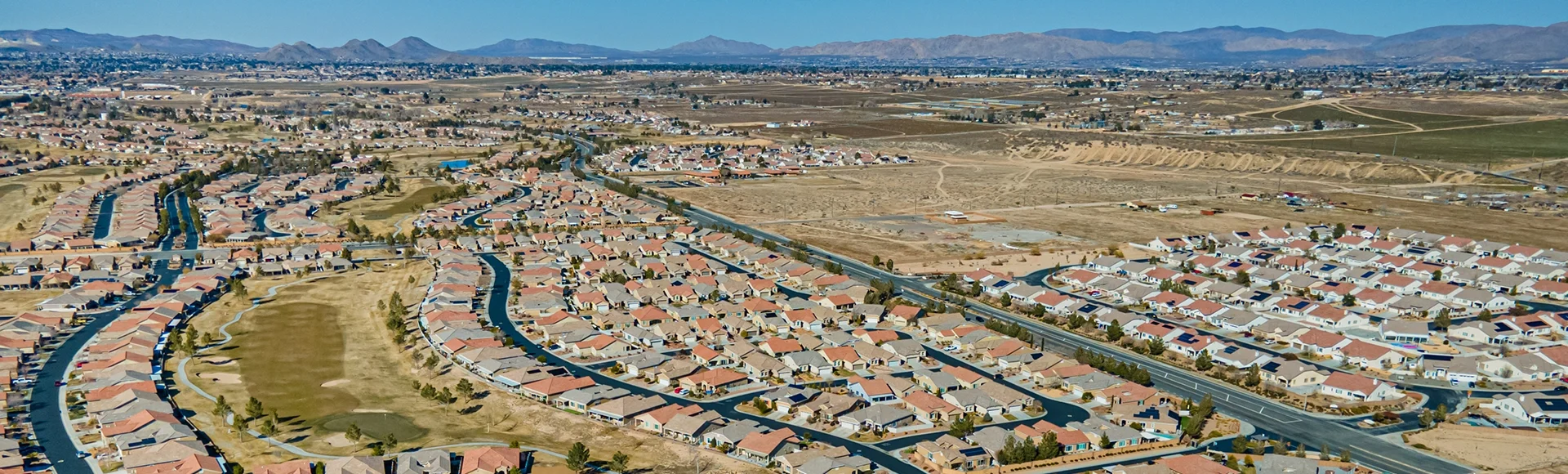 Apple Valley, California –Aerial city view drone photo toward Apple Valley California, CA with many new build houses, homes