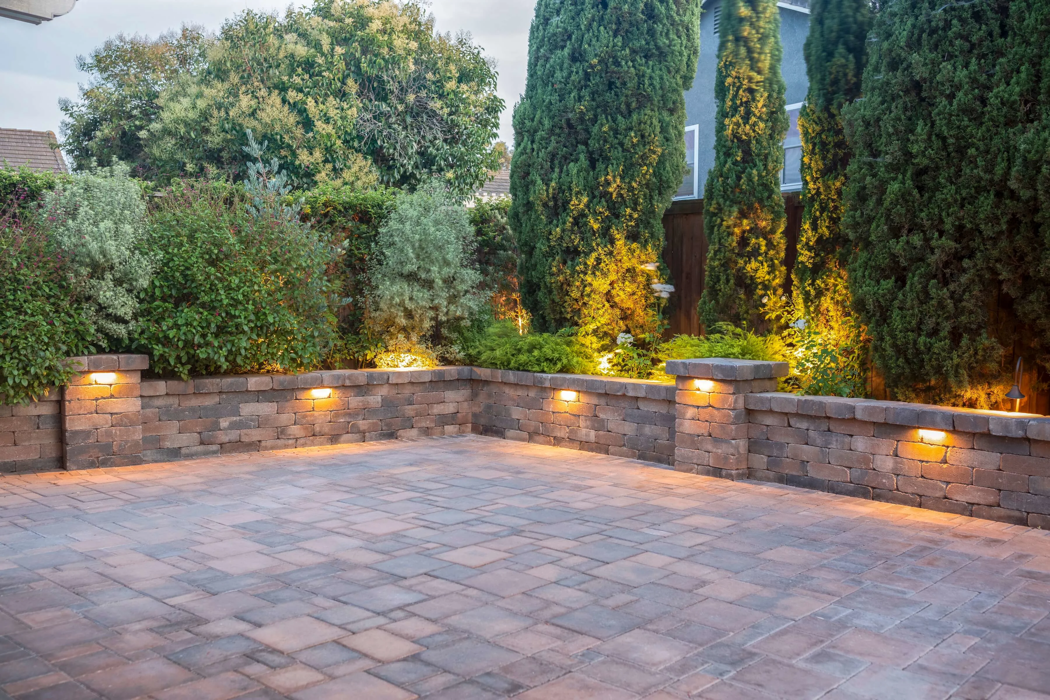 Paver courtyard with sitting wall and built-in lighting 