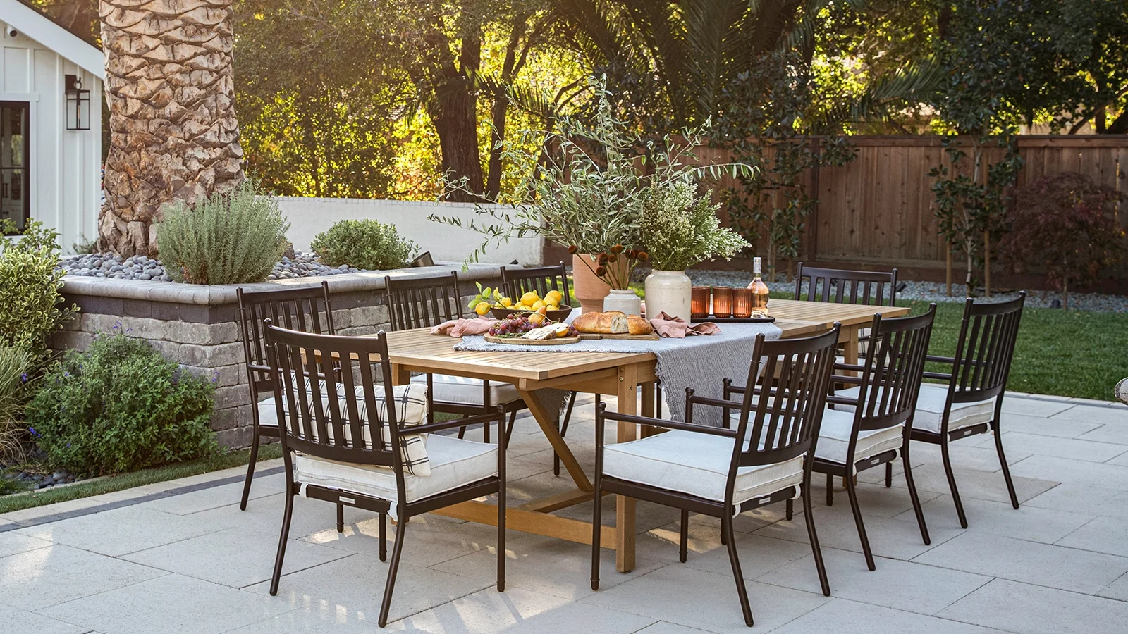 Beautiful paver patio with table next to palm tree. 