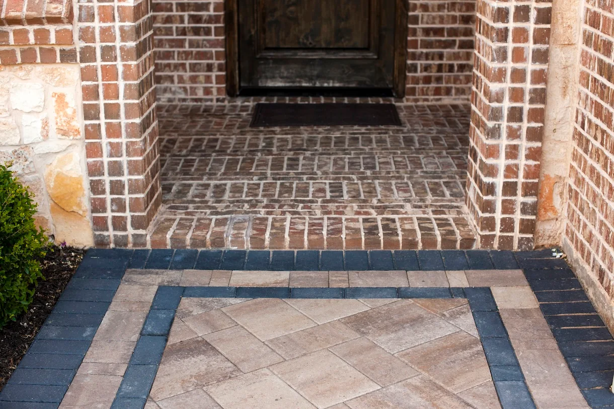Paver walkway in Texas leading to brick front entry