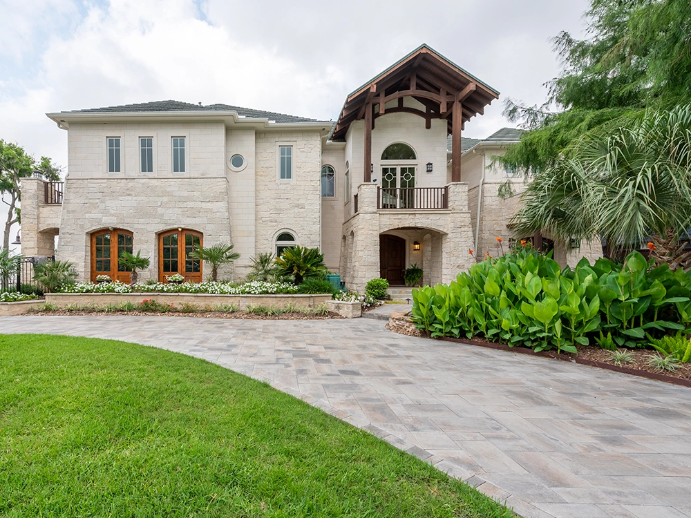 Large Houston home on long winding paving stone driveway