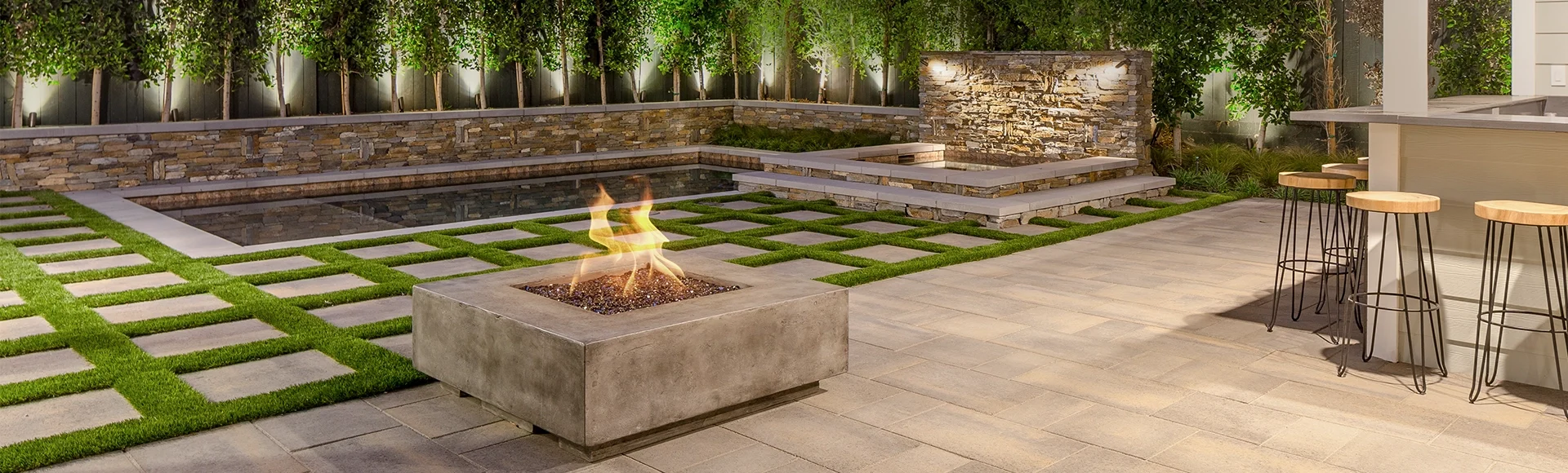 Backyard fire pit and pool deck created by System Pavers