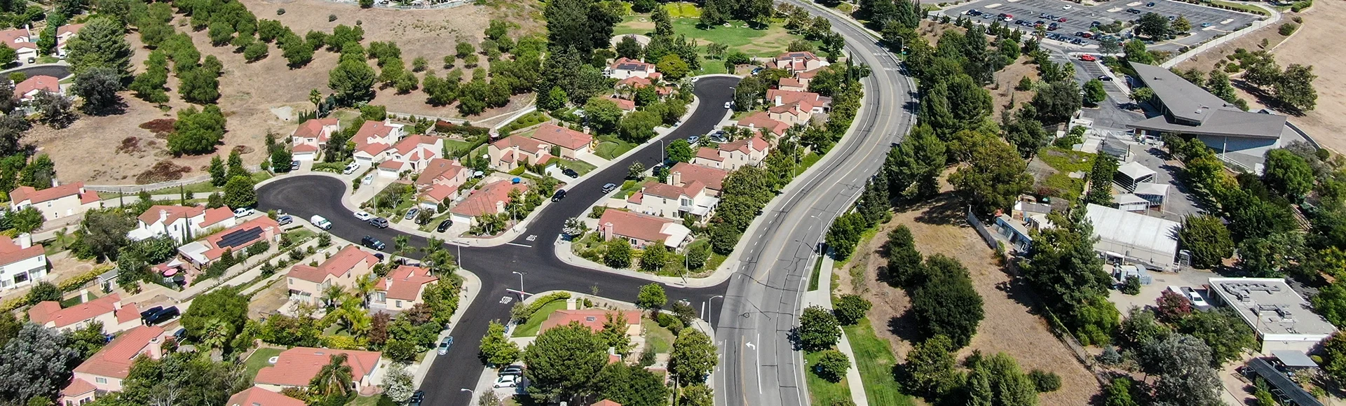 Aerial view of small neighborhood with dry desert mountain on the background in Moorpark