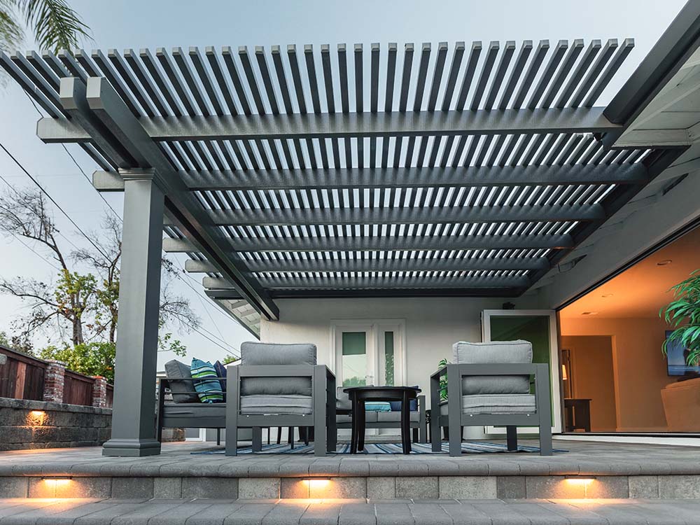Modern pergola over a paver patio with built-in lighting