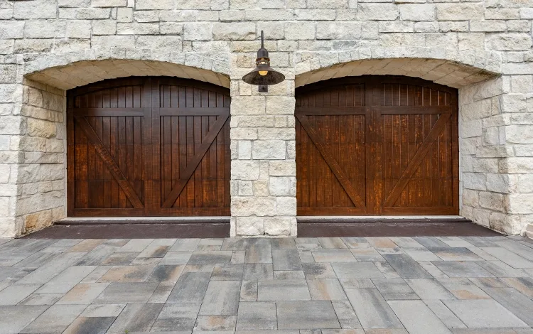 Houston paving stone driveway with two wooden garage doors.