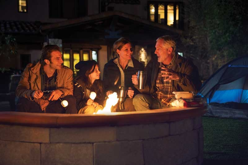 people making s'mores at a fire pit