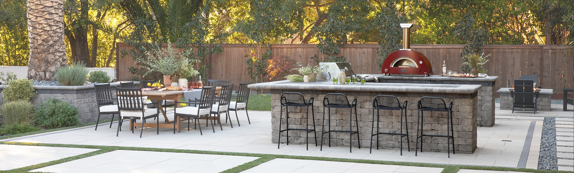 Outdoor stone kitchen with BBQ, grill, pizza oven, stone bar and patio