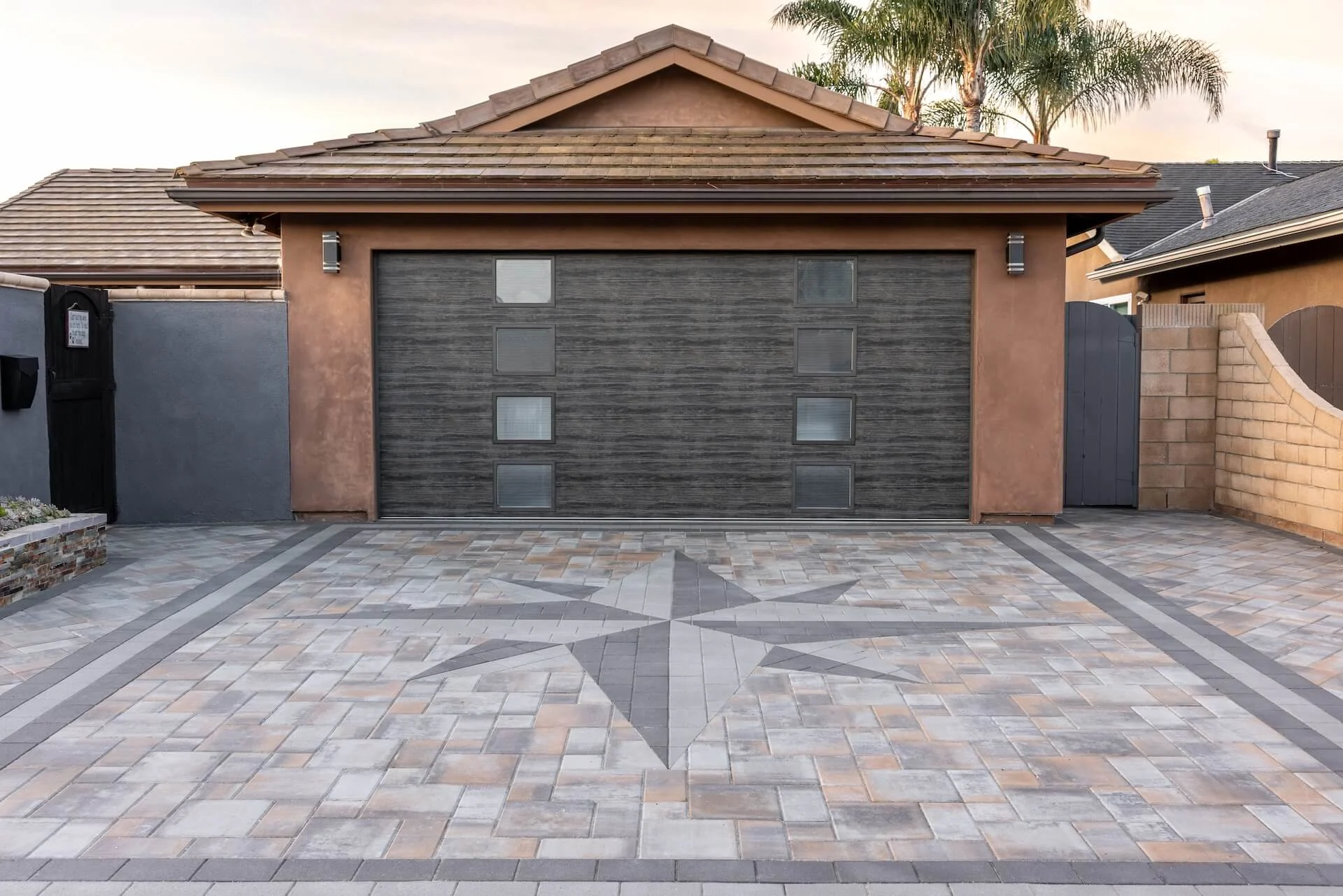 Ultimate curb appeal driveway with nautical star paving stone pattern and mixed paver colors