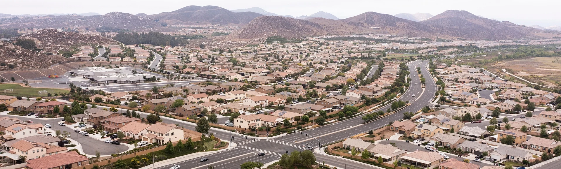 Aerial view of a sprawling neighborhood of family homes in Menifee, California, USA.