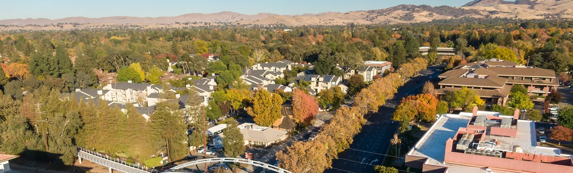 Aerial view of Walnut Creek, California, USA, featuring a pedestrian bridge connecting to the surrounding neighborhood. Showcases urban planning and accessibility.
