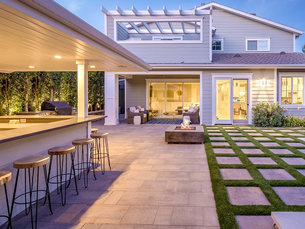 Sandy Springs home with paving stone patio, artificial turf details and stand-alone fire pit. 