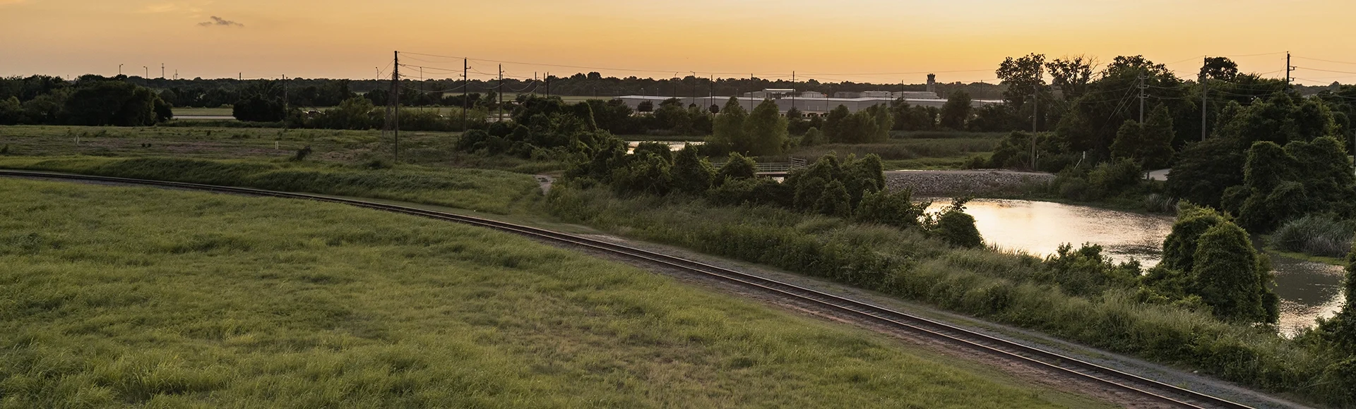 Sunset in Sugar Land, Texas with a view of the creek and railways