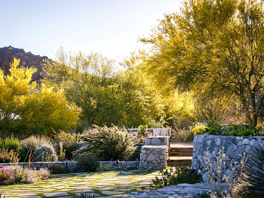 Paving stone patio and stone wall in a backyard in Rolling HIlls, California