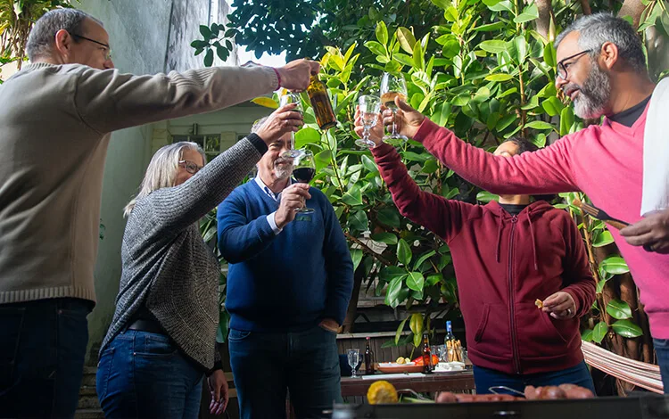 Friends toasting on patio