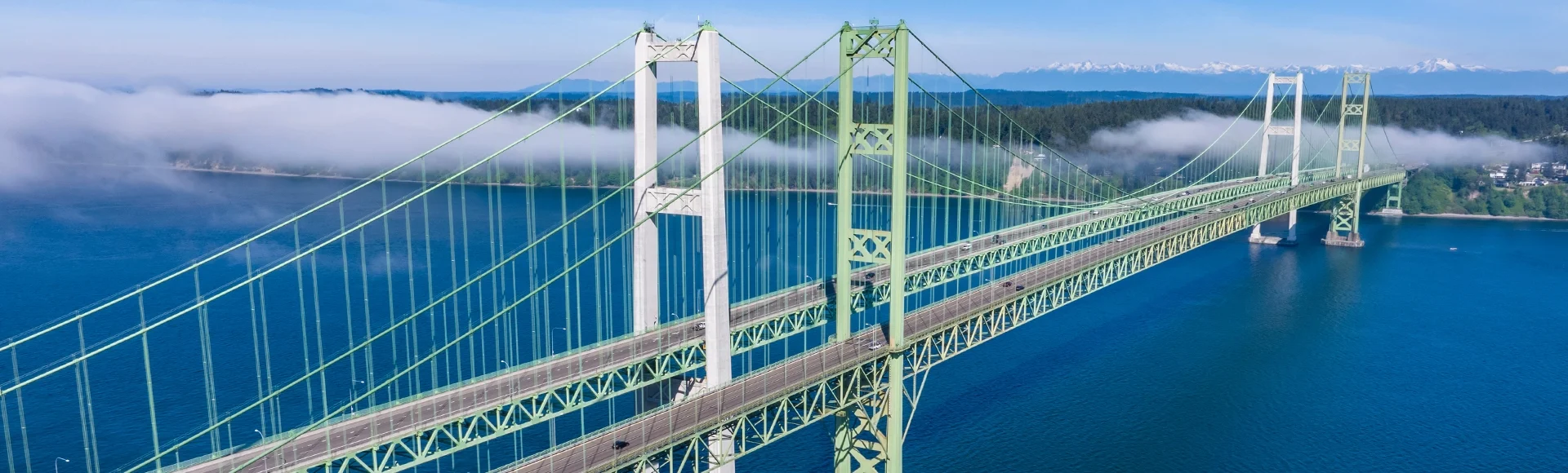 Aerial view of the Narrows bridge in Tacoma Washington with clouds drifting in