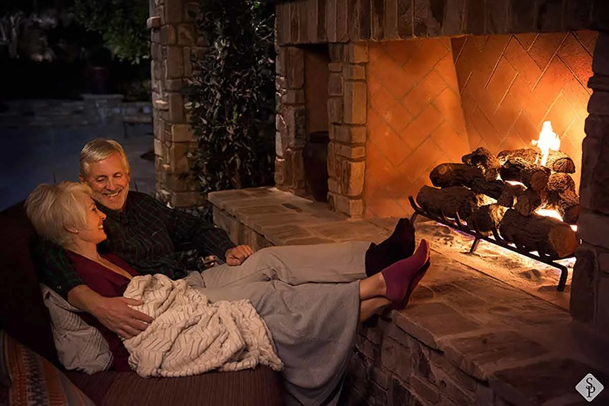 couple at outdoor fireplace