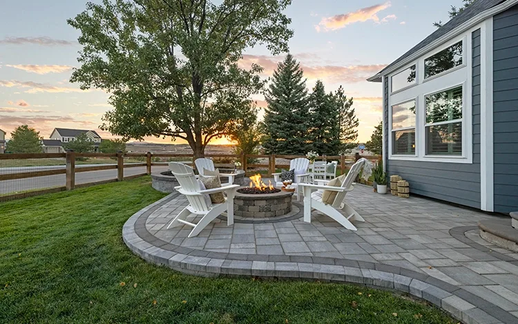 Home paver patio with built-in fire pit. 