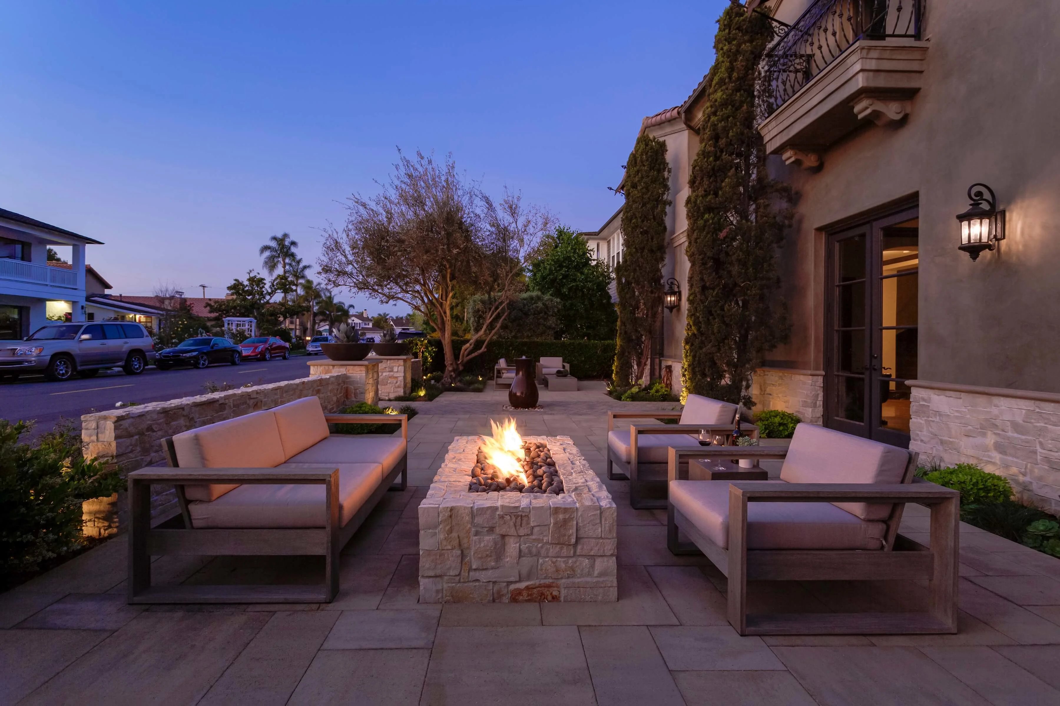 Front yard fire pit and paver patio seating area in the evening