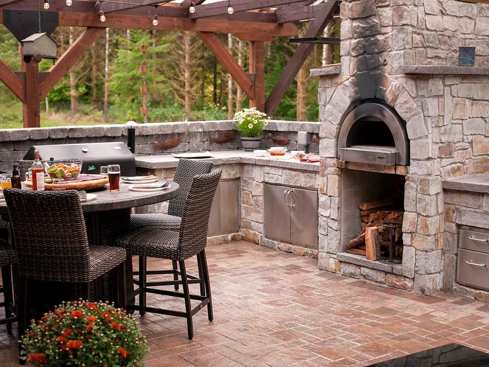 Outdoor patio with kitchen and wood fire pizza oven