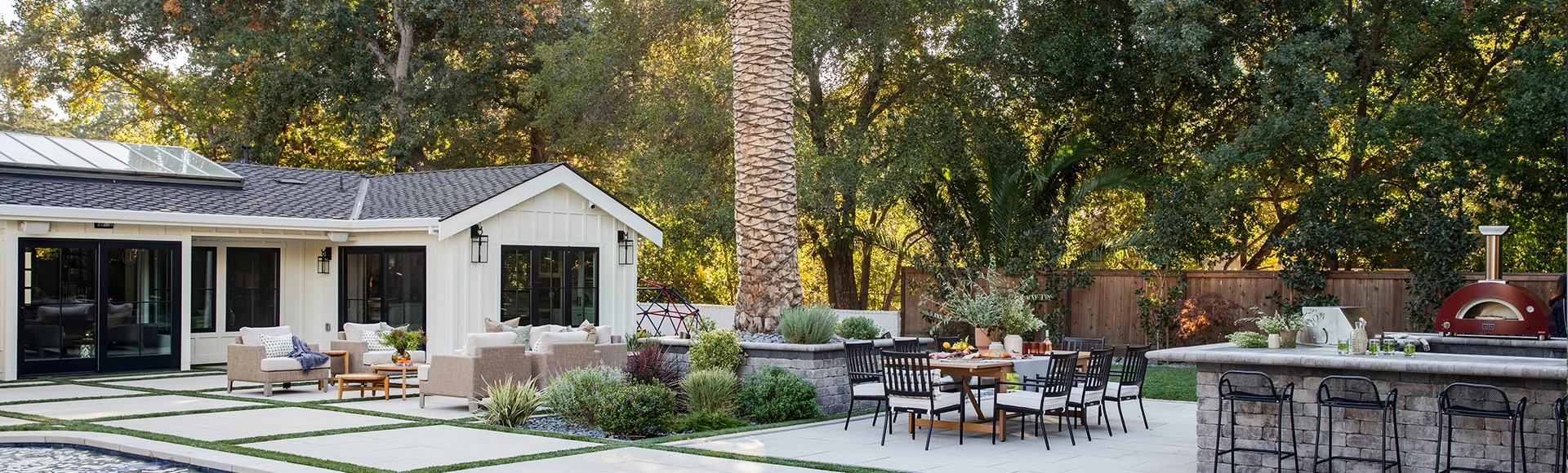 The ultimate dream backyard with paver patio, outdoor kitchen, and lounge area