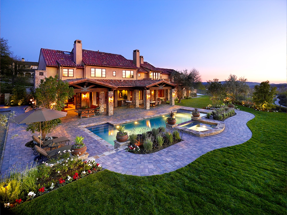 Beautiful California backyard with pavers around pool and patio. 