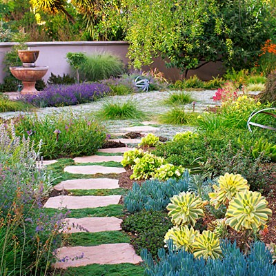 paver pathway with colorful bushes