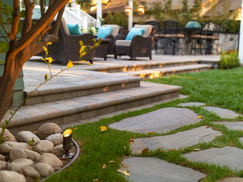 Nice raised paving stone patio with stairs, lighting and paving stones