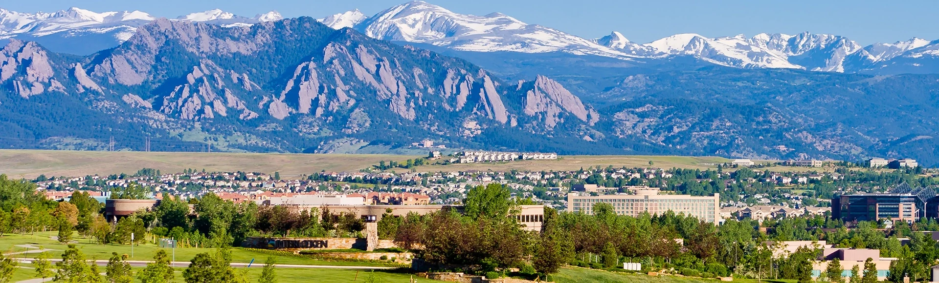 Interlocken Business Park with housing development in background, in Broomfield, looking toward Boulder, the flatirons, and the Indian Peaks, Broomfield County, Colorado