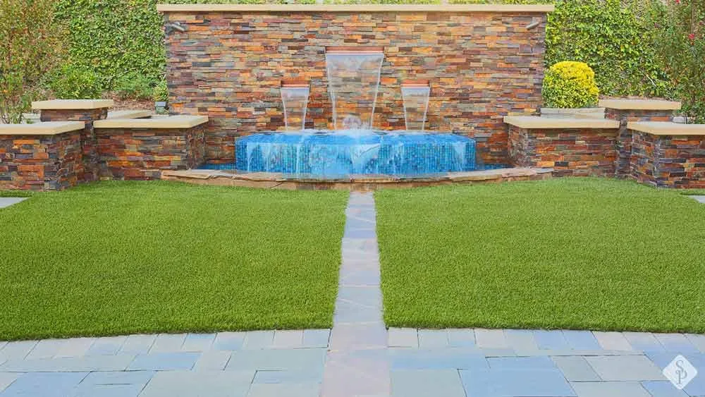 turf, pavers, and waterfall