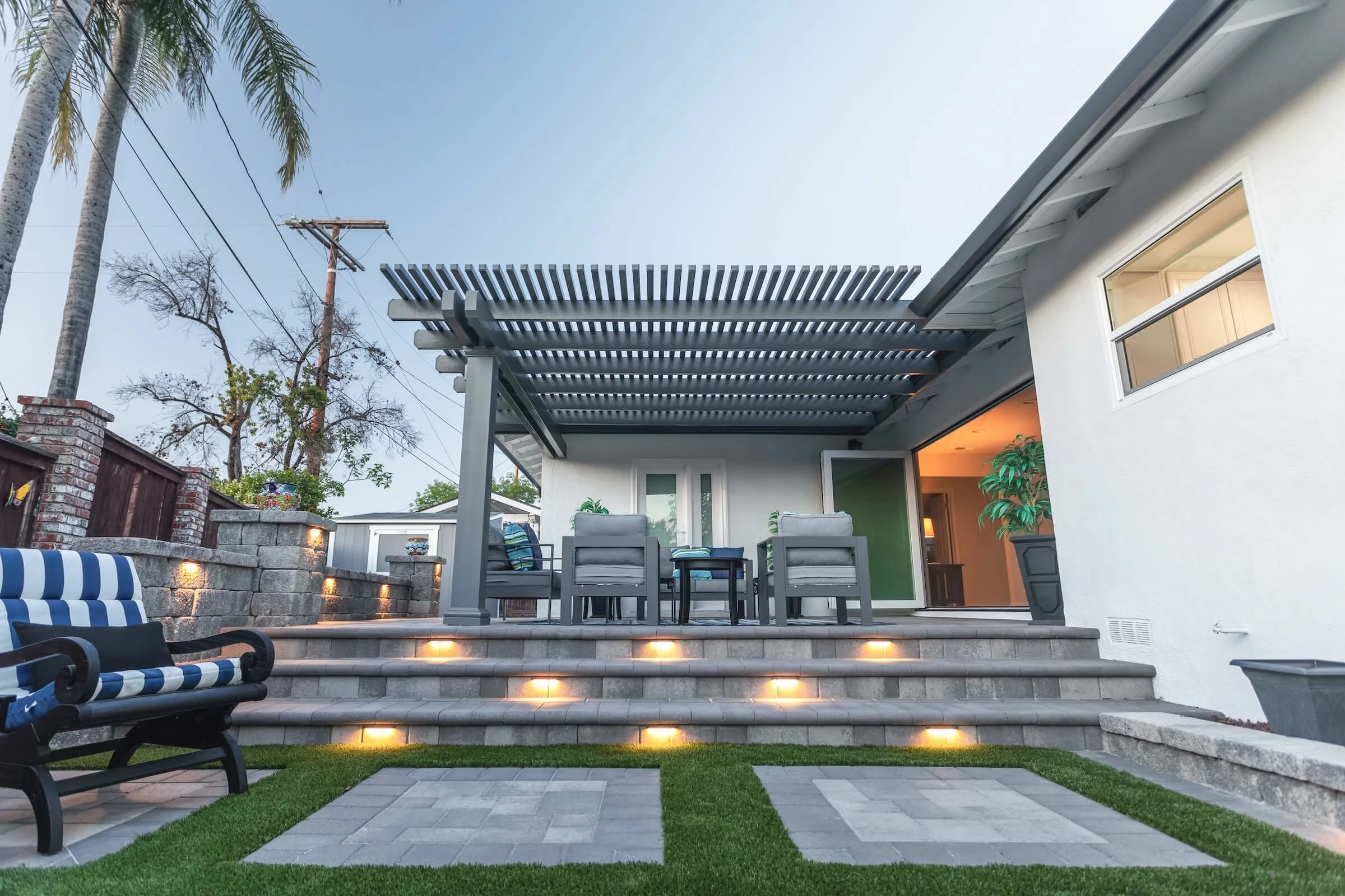 Southern California backyard remodel with paver patio, artificial turf, pergola, sitting walls