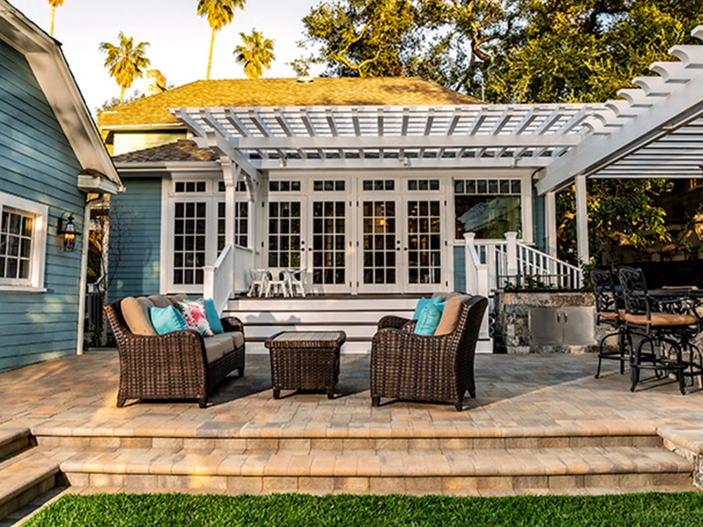 Outdoor paving stone patio with pergola and built-in grill station in Los Angeles. 