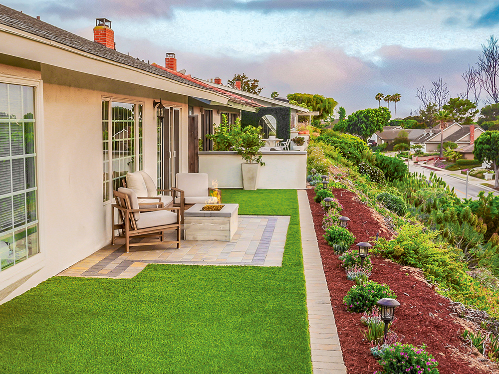 Landscape on a hill with turf lawn and hardscape patio
