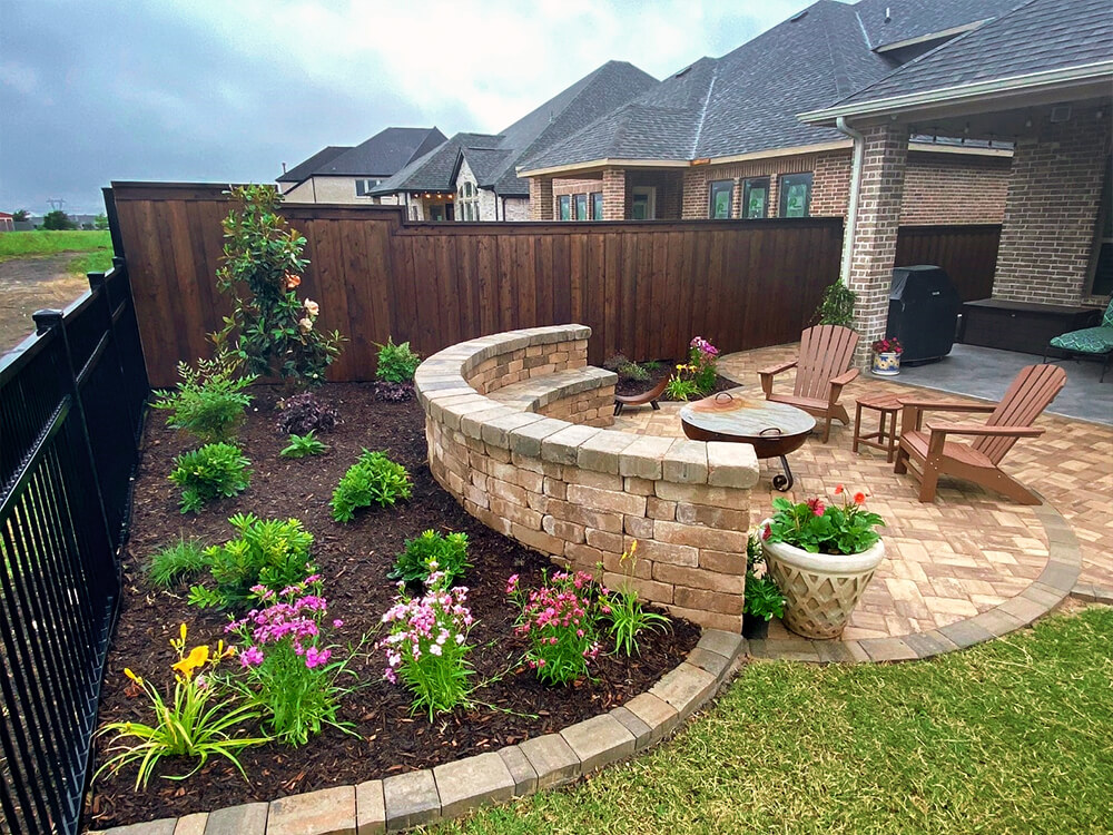 Paving Stone Patio with paving stone built-in seat and wall with firepit and landscaping