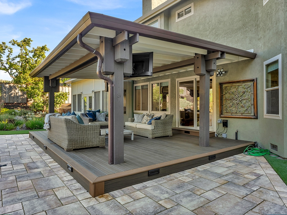 Paving stone patio with a pergola for cozy outdoor living. 