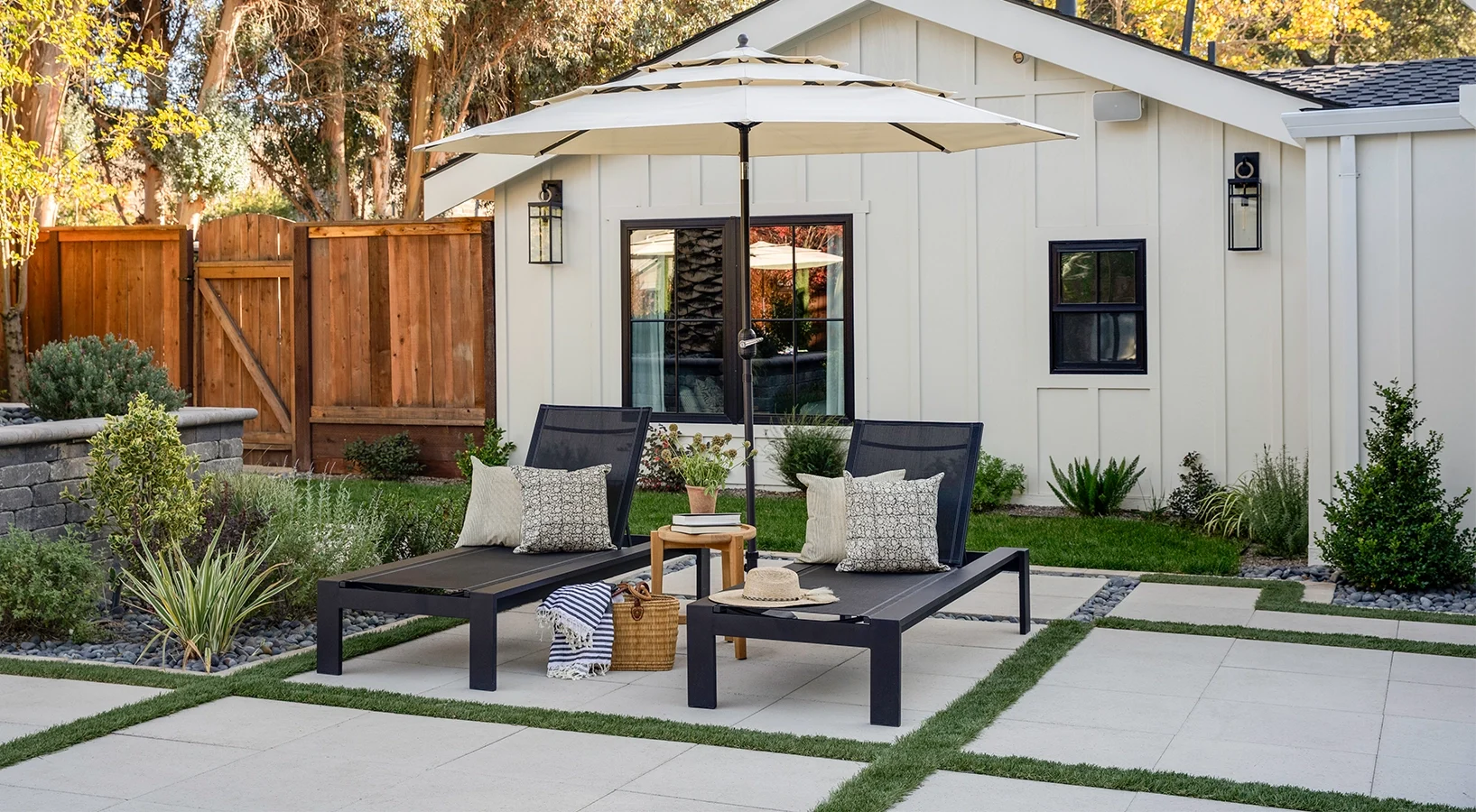 Paver patio with lounge chairs. Paver planter box in background.