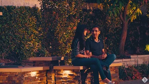 couple sitting on a stone wall