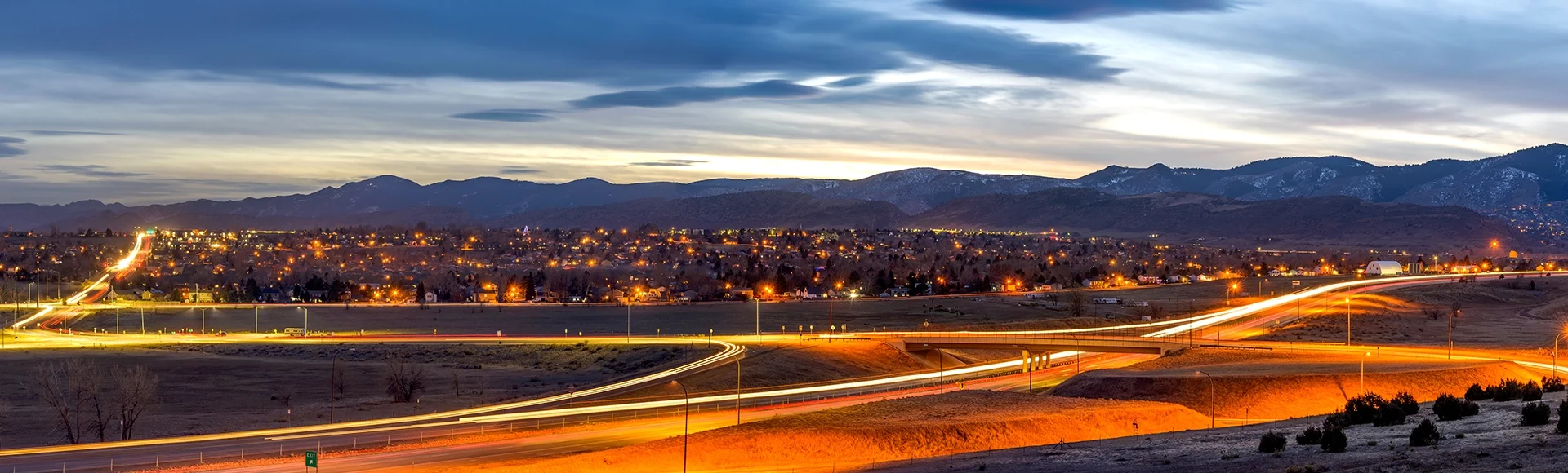 A panoramic dusk view of Littleton at the foothill of Front Range of Rocky Mountains on a stormy winter evening. Southwest of Denver, Colorado, USA