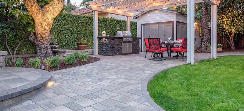 Backyard paver patio with pergola and walkway
