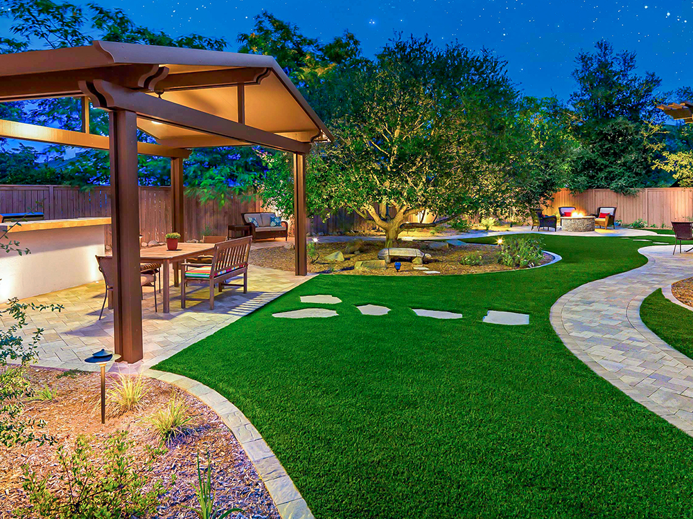 Landscaped yard with pergola and hardscaped paver patio