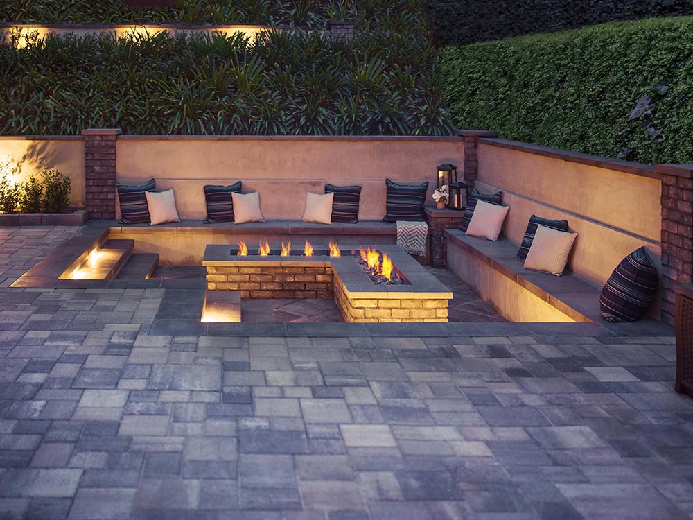 L-shaped fire pit on paver patio with seating