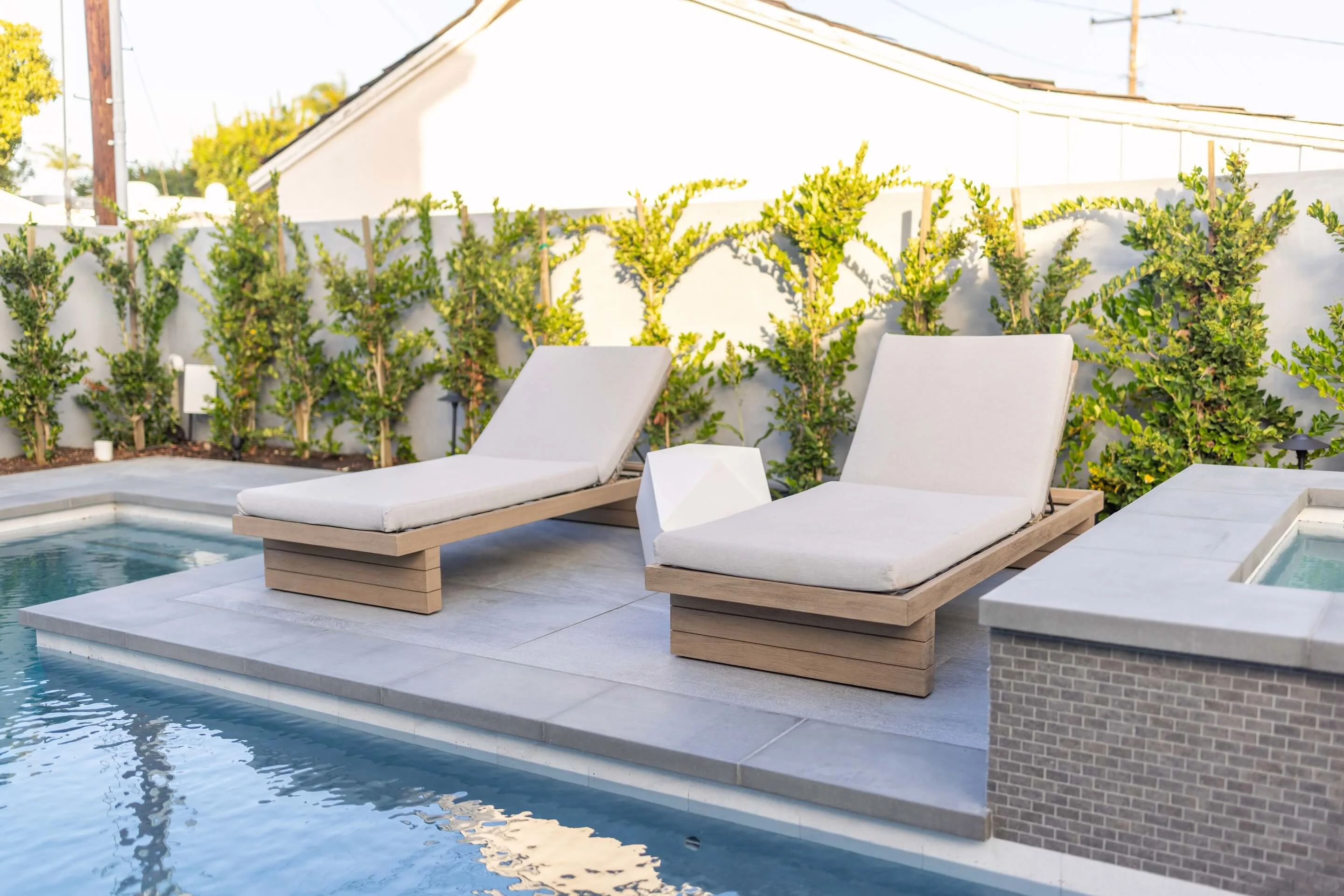 Large format paver pool deck with patio lounge chairs
