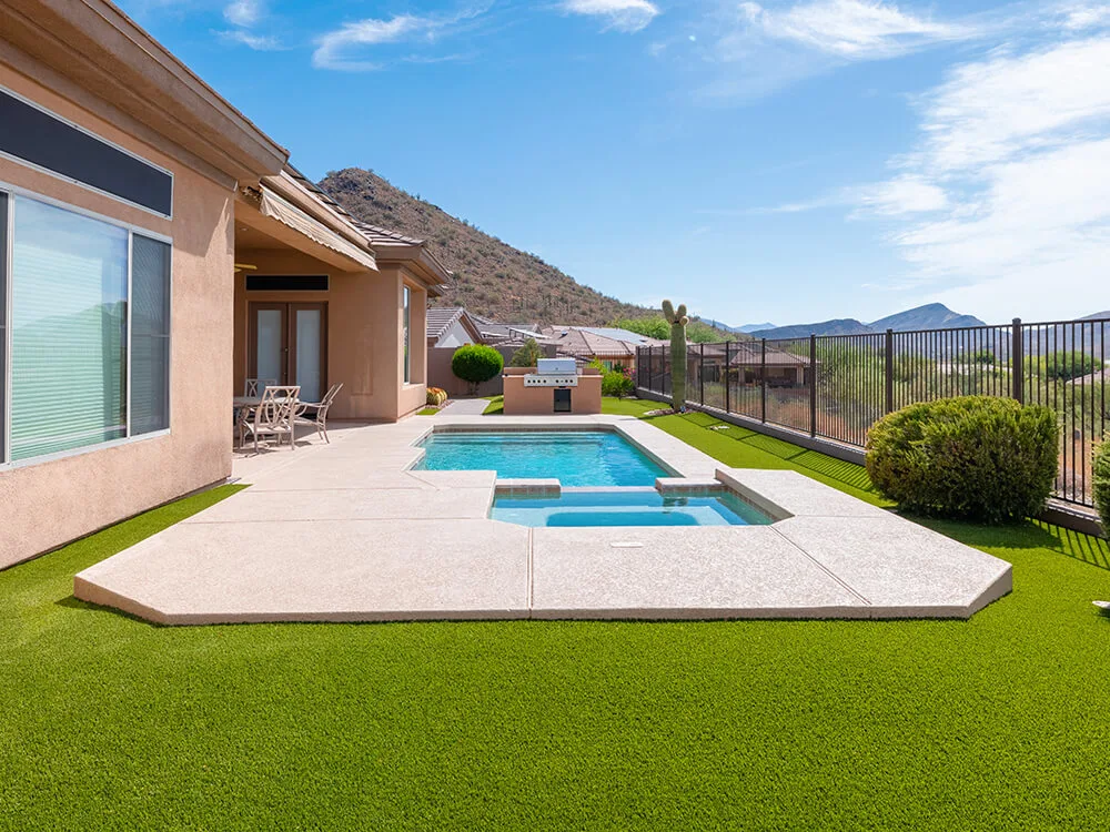 Paver pool deck and artificial turf installed by System Pavers