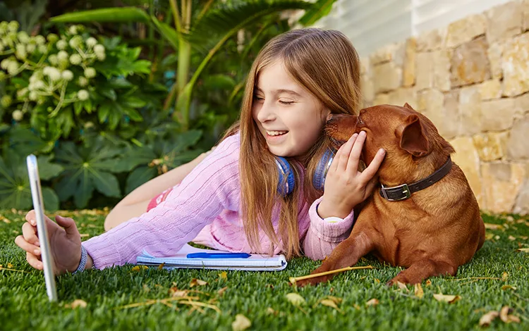 girl and dog on turf