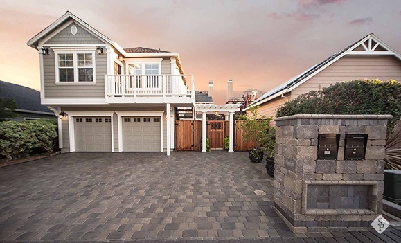 stone mailbox and paver driveway